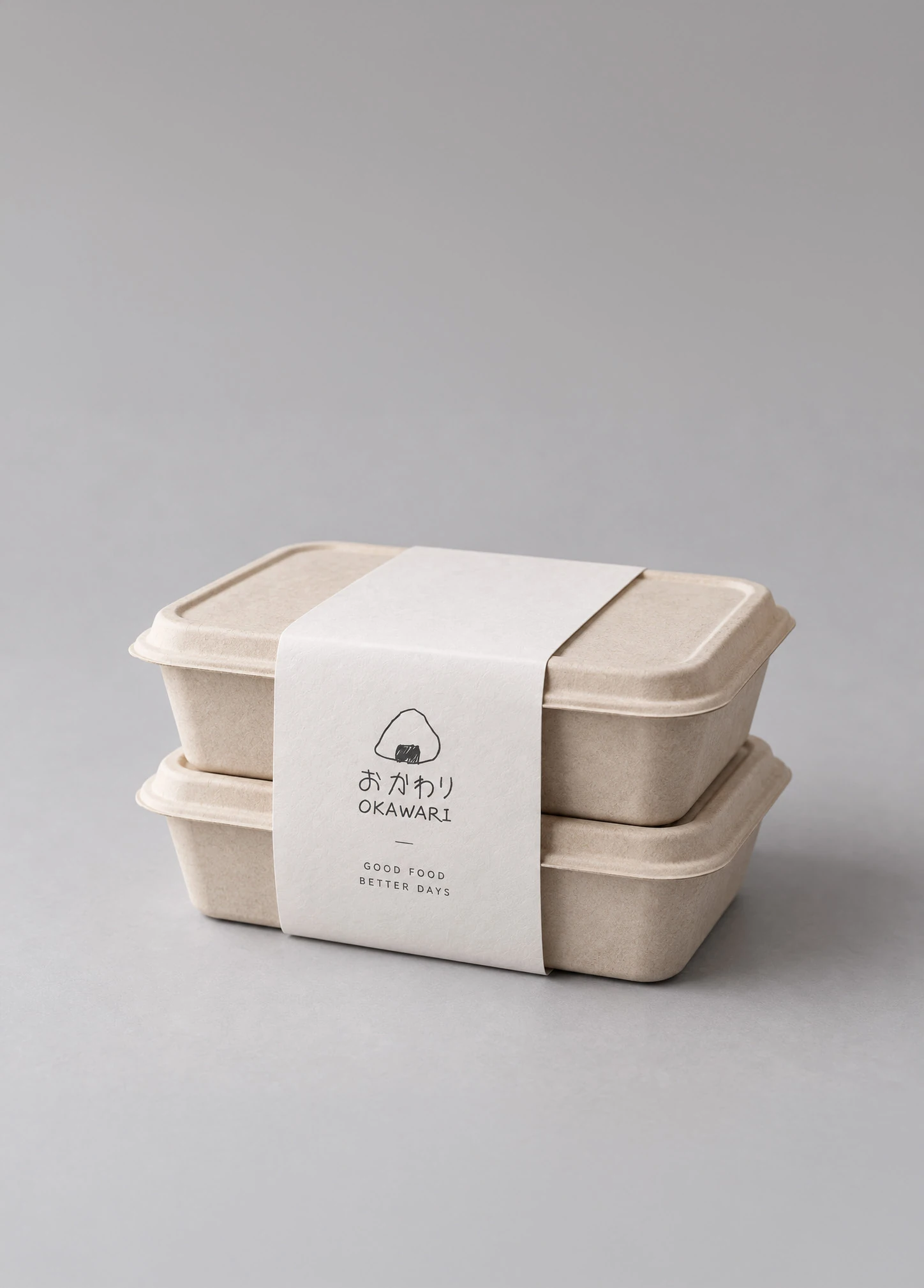 Two natural fibre food boxes with an OKAWARI paper sleeve